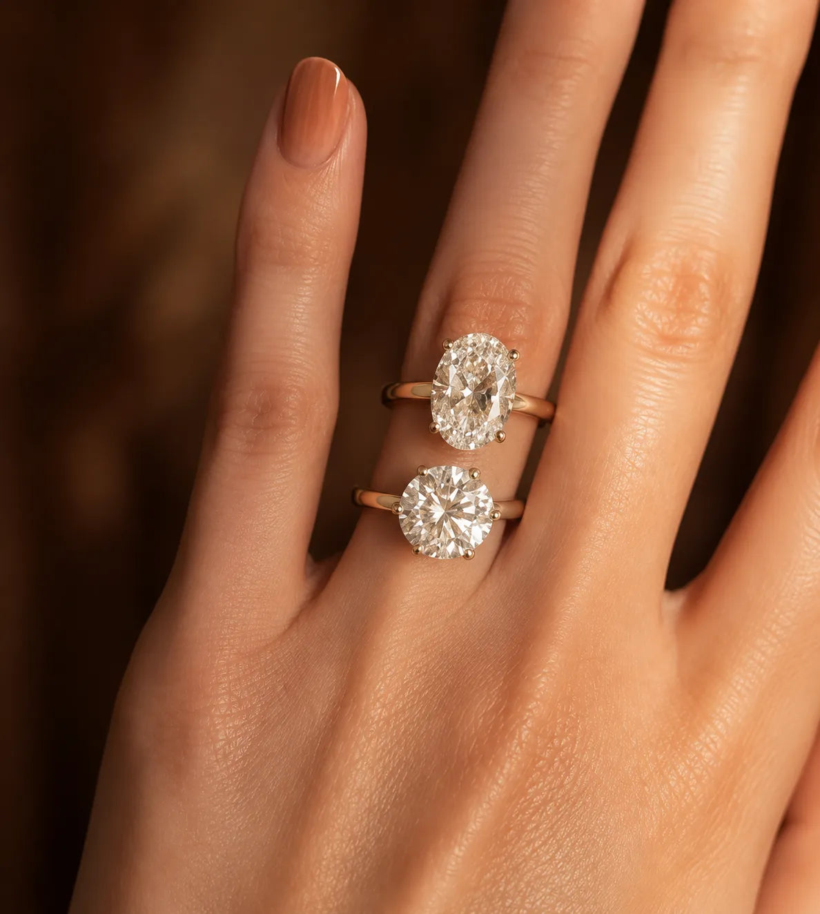 Oval and round natural diamond engagement rings shown side by side for shape, sparkle and finger-coverage comparison